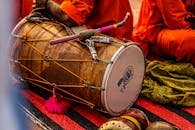 Close-up of a traditional dhol drum with vibrant colors in a cultural setting.